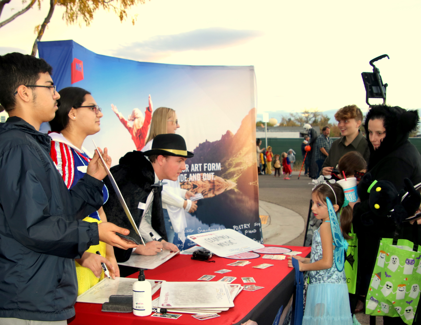 Volunteers staffing the MADC booth during an outdoor event
